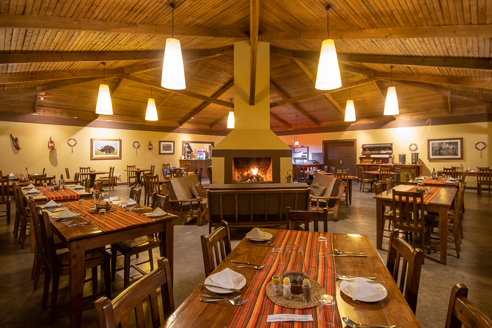 Rhino Lodge dining room interior with cosy fireplace
